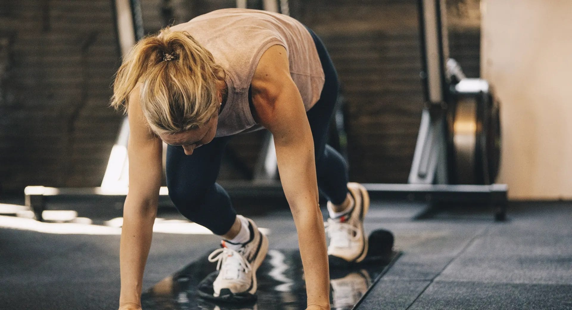 Woman doing burpees on training at Activate